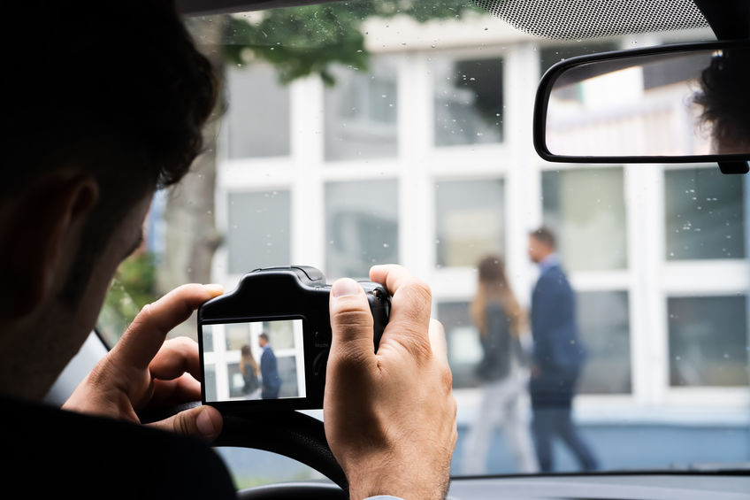 Private investigator obtaining video footage of a man and a woman involved in an extramarital affair.