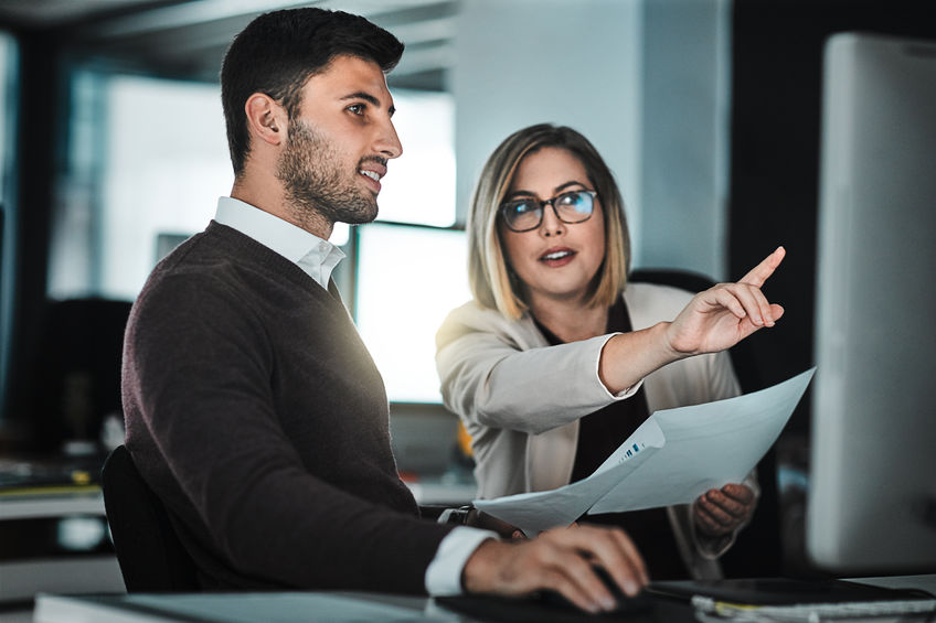 A manager pointing out her concerns to the digital forensics investigator as he begins a Digital Forensics Computer Forensics Investigation.