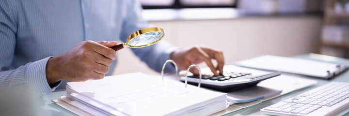 A man examining the expenses of an invoice