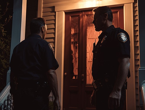 Men posing as police officers outside a house