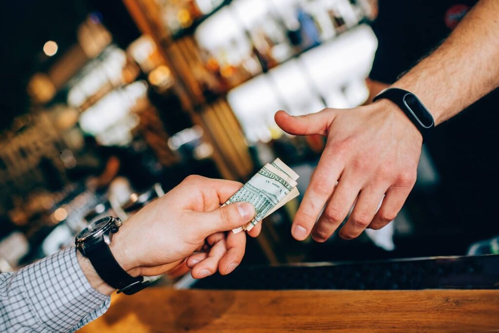 Surveillance services in Integrity Audits, as the surveillance investigator hands the bartender money and watches to see if there will be employee theft.